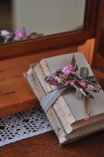 a book with flowers on top of it on a table at Obelix Guesthouse in Lüderitz