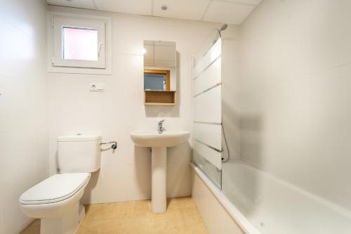 a white bathroom with a toilet and a sink at Apartment La Loma Mar Menor Golf Resort in Los Martínez
