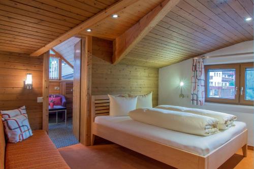 a bedroom with a large bed in a wooden room at Apart EVA in Serfaus