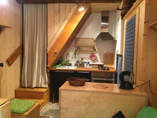 a small kitchen with a sink and a stove at La Tana dell'Orso in Forni di Sopra