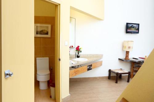 a bathroom with a toilet and a sink at Goha Hotel in Gonder