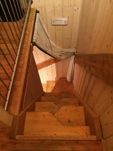 an overhead view of a staircase in a wooden house at La Tana dell'Orso in Forni di Sopra