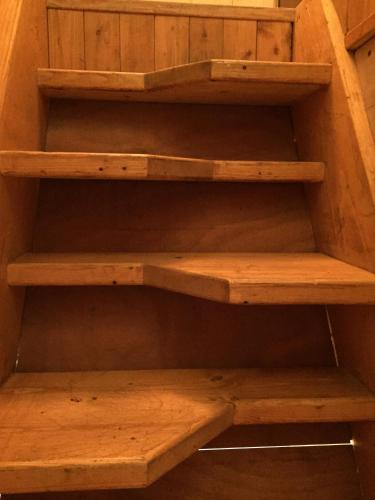 a shelf in a closet with wooden shelves at La Tana dell'Orso in Forni di Sopra