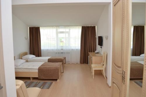 a bedroom with two beds and a mirror at Park-Hotel Diyevo Gorodishche in Yaroslavl