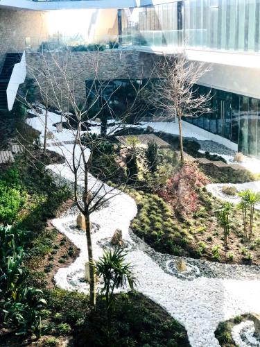 a garden with rocks and trees in a building at Royal Obidos Scenic Resort in Casal da Lagoa Seca