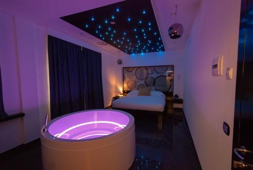 a bathroom with a tub in a room with a bed at JC Hotel in Rome