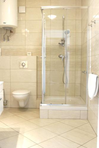 a bathroom with a shower and a toilet at Pokoje Gościnne Dom Literatury in Warsaw