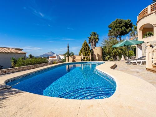 a swimming pool in a villa with blue water at Holiday Home Zindel by Interhome in Balcon del Mar