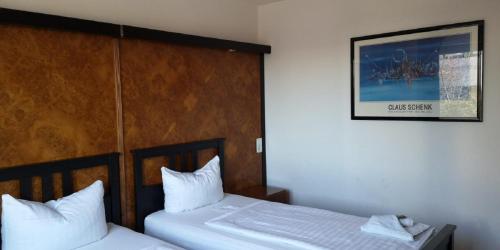 two twin beds in a room with a picture on the wall at GZ Hostel Bonn in Bonn