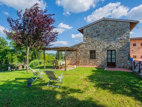 an image of a stone house with chairs in the yard at Holiday Home I Lecci by Interhome in Lucolena in Chianti