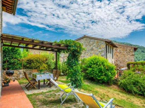 a patio with chairs and a table with a grill at Holiday Home La Corte by Interhome in Lucolena in Chianti
