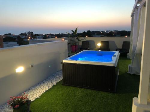 a swimming pool on the roof of a house at B&B Punta Stilo in Torre San Giovanni Ugento