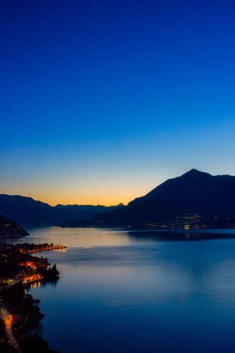 a view of a large body of water at dusk at Fall In Love with Como Lake in Bellano