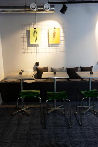 a room with tables and green chairs in it at City Central Hotel Örebro by First Hotels in Örebro