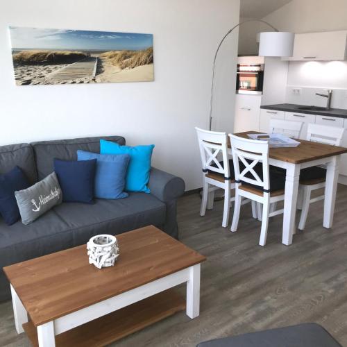 a living room with a couch and a table at Ferienwohnung Oberdeck 2.06 in Glowe