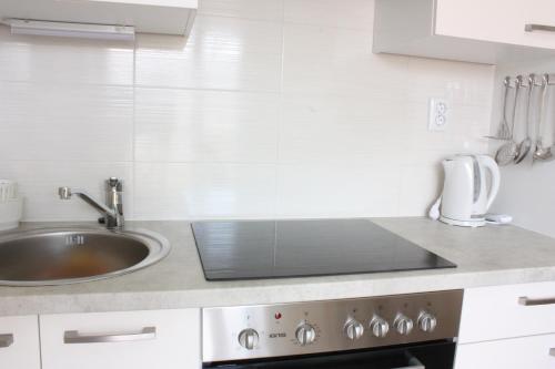 a kitchen with a sink and a stove top oven at Krznar - Stari grad Pag in Pag