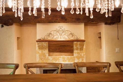a dining room with a table and chairs and a chandelier at Case di Sotto, House & Breakfast in Locarno
