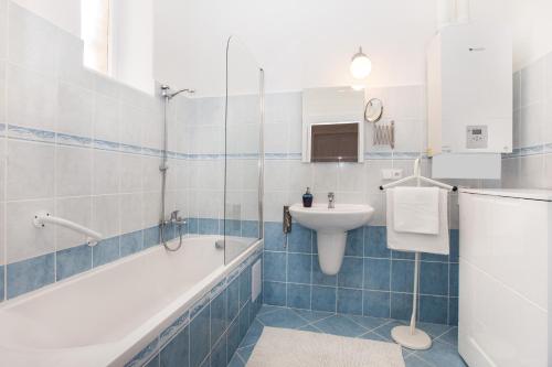 a bathroom with a tub and a sink and a toilet at Old Town Home Prague in Prague