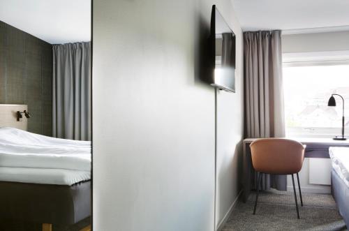 a hotel room with a bed and a window at Comfort Hotel Bergen in Bergen