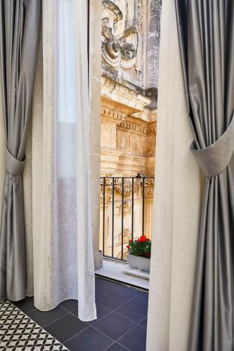 a window with curtains in front of a building at Donna Teresa Guest House in Lecce