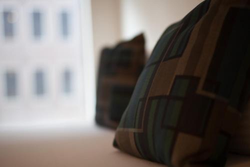 a close up of a pillow on a couch at CitiClub Hotel Melbourne in Melbourne