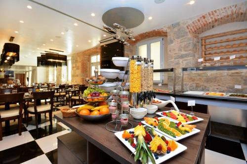 a table with food on it in a restaurant at Jupiter Heritage Hotel in Split