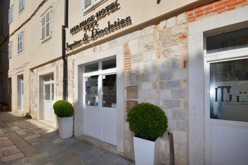 a facade of a building with a white door at Jupiter Heritage Hotel in Split