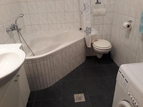 e bagno con servizi igienici, vasca e lavandino. di Apartment Zdravko - with parking a Omiš (Almissa)