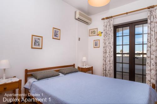 Postel nebo postele na pokoji v ubytování Akisol Albufeira Oura