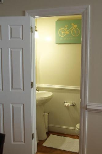 a bathroom with a sink and a bike sign on the wall at Your Home Away For Home, Convention Center. 96 WALK SCORES. in Washington, D.C.