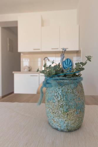 a blue vase with a plant in it in a kitchen at Villa Sunset in Rogoznica