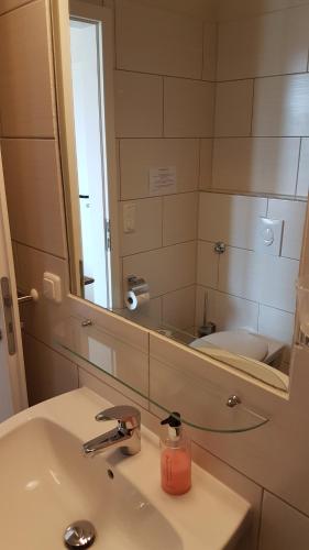 a bathroom with a sink and a mirror at Halbinsel Resort Peenemünde in Peenemünde