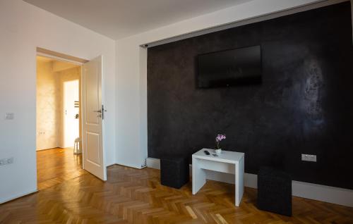 una habitación con una mesa blanca y una pared negra en White Spacious Apartment, en Sibiu