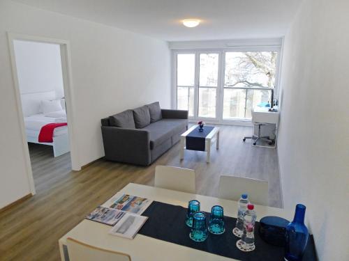 a living room with a couch and a table at Apartment BHMS City Campus by Interhome in Lucerne