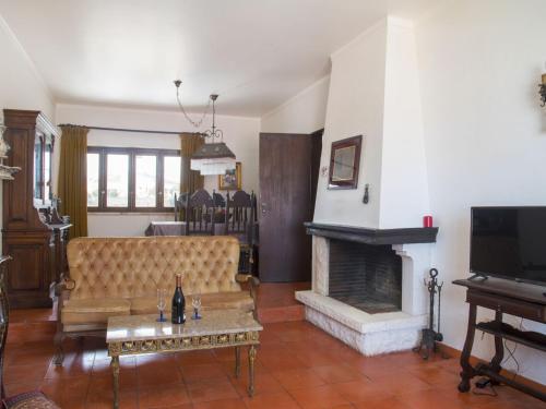 a living room with a couch and a fireplace at Villa Vila Hortencia by Interhome in Ericeira