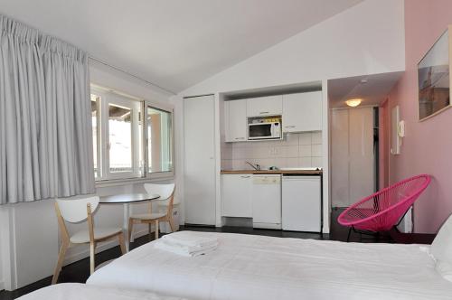 a bedroom with a bed and a table and chairs at Temporesidence Chateauneuf in Bayonne