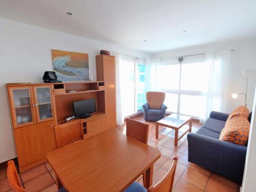 a living room with a couch and a table at Apartment Playasol 1 by Interhome in Les Cases d'Alcanar