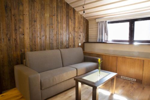 a living room with a couch and a table at Koliba u Cerneho Medveda in Zlín
