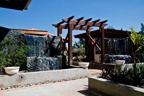 a water fountain in a garden with a waterfall at Aanari Hotel & Spa- Mauritius in Flic-en-Flac