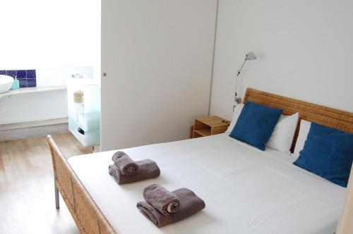 a bedroom with a bed with towels on it at SitgesNow Port Alegre Mar in Sitges