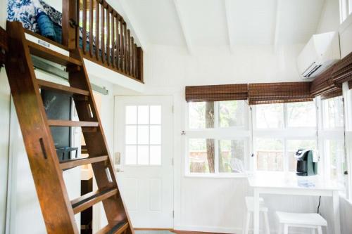 a staircase in a tiny house with a desk at The Cottage Treehouses in Hermann