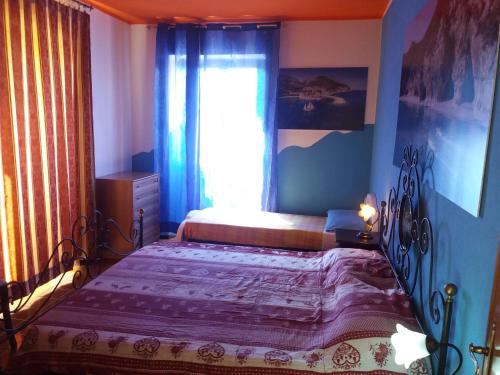 a bedroom with a bed and a window at B&B Bella Vista in Dorgali