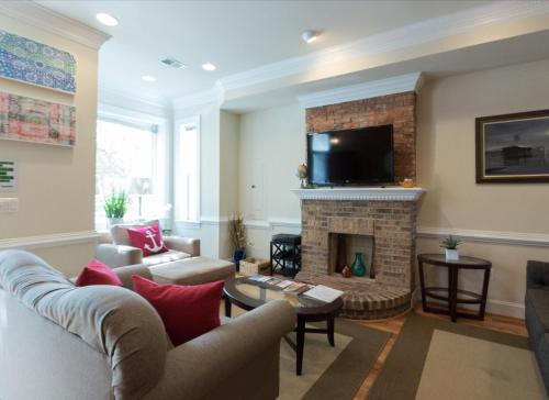 a living room with a fireplace and a tv at Your Home Away For Home, Convention Center. 96 WALK SCORES. in Washington, D.C.