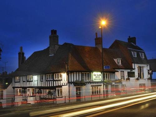 a large building on a street with a street light at The Lamb Inn in Eastbourne