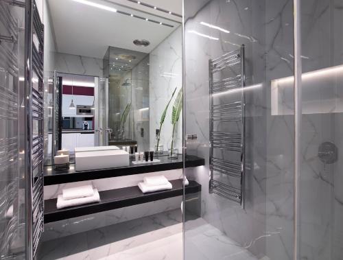 a modern bathroom with a glass shower stall at Athens Ikon in Athens