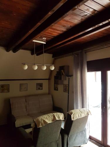 a living room with a couch and two chairs at Viola i Detelina Apartments in Perućac