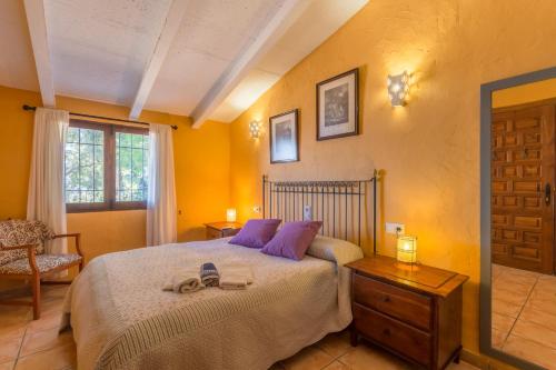 1 dormitorio con 1 cama con almohadas moradas en Valldemossa - 281388, en Valldemossa