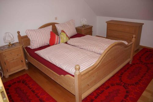 a bedroom with a wooden bed with two night stands at Ferienwohnung im Hainertal in Heigenbrücken