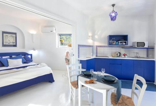 a blue and white bedroom with a bed and a table at Villa Ravino Secret Retreat in Ischia