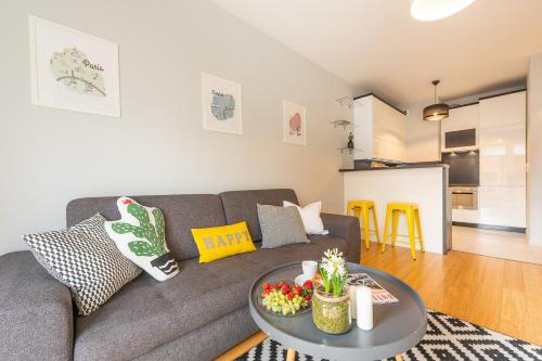 a living room with a couch and a table at Apartamenty Tespis - Francuska Atal Park in Katowice